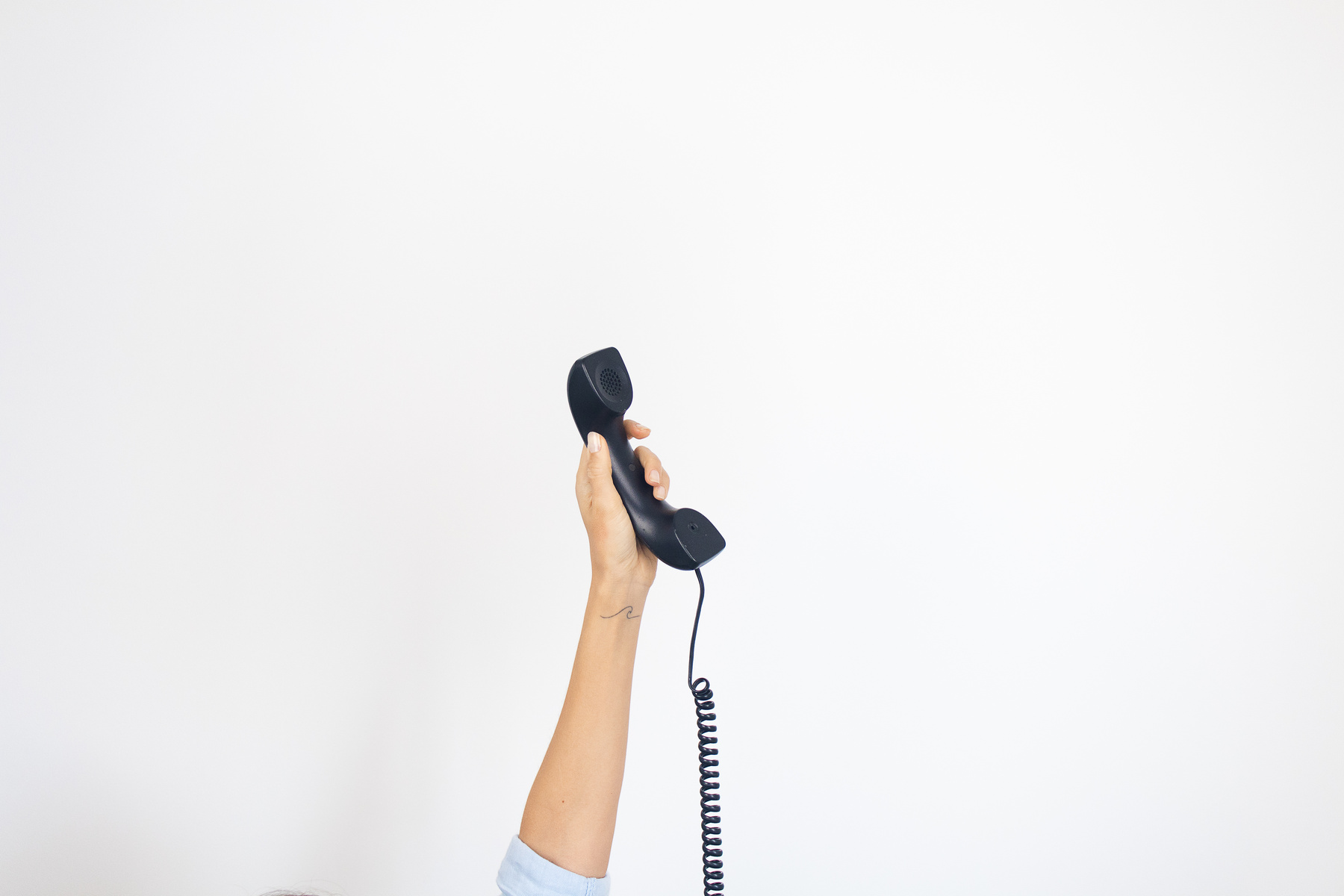 Arm Holding a Telephone Up in the Air